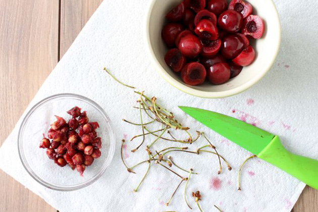 Cherries cut up on white paper towel